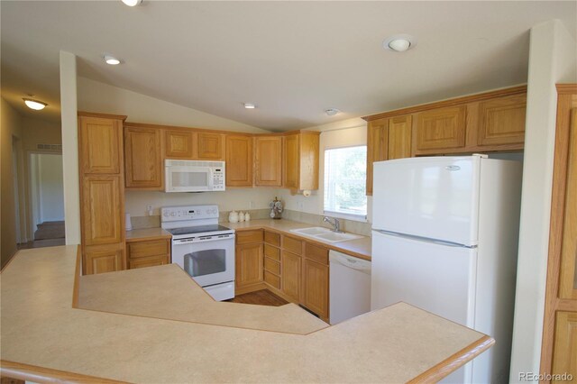 kitchen with white appliances, sink, and lofted ceiling