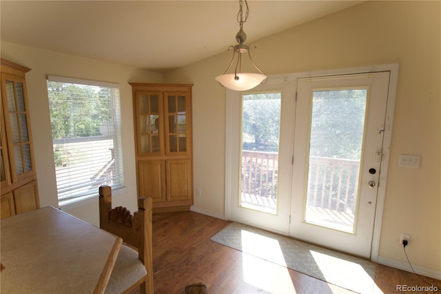 dining room with lofted ceiling, light hardwood / wood-style flooring, and a wealth of natural light