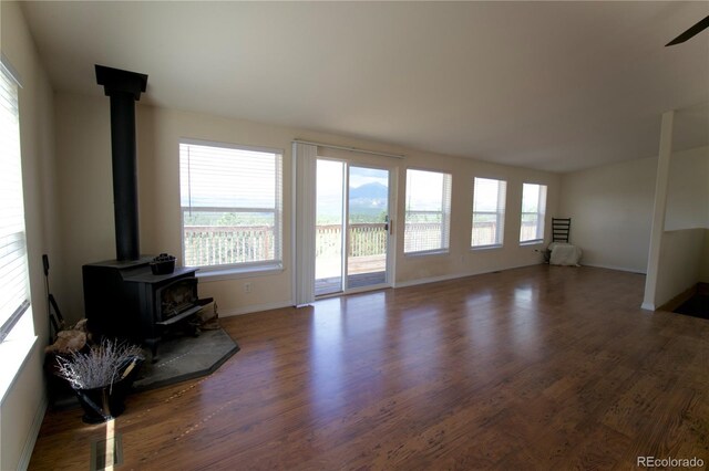 living room with hardwood / wood-style flooring and a wood stove