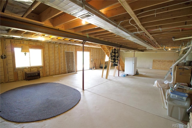 basement with white refrigerator