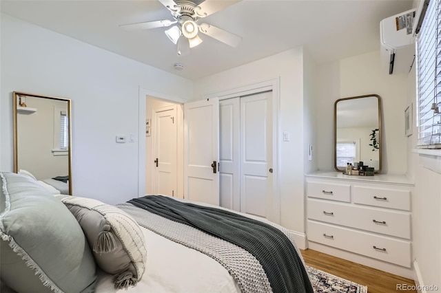 bedroom featuring a closet, ceiling fan, and light hardwood / wood-style flooring