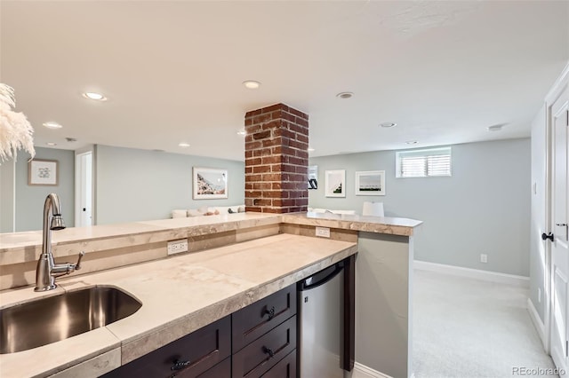 kitchen featuring light carpet, sink, and refrigerator