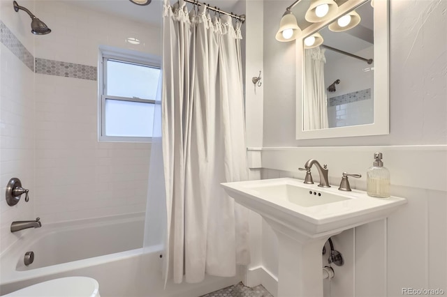 full bathroom with a sink, toilet, and shower / bathtub combination with curtain