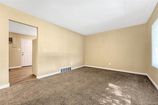 spare room featuring a wealth of natural light and carpet flooring