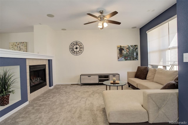 living room featuring ceiling fan, a fireplace, and light carpet