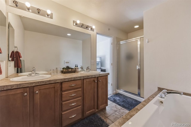 bathroom featuring independent shower and bath, vanity, and tile patterned floors