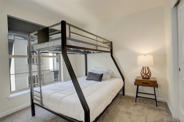 bedroom with multiple windows and carpet floors