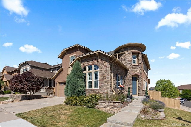 10840 Valleybrook Cir, Highlands Ranch, CO 80130 - view of front facade featuring stone siding, concrete driveway, a front yard, and stucco siding