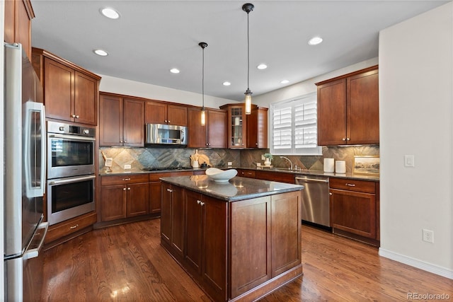 10840 Valleybrook Cir, Highlands Ranch, CO 80130 - kitchen featuring stainless steel appliances, dark wood-style flooring, backsplash, and recessed lighting