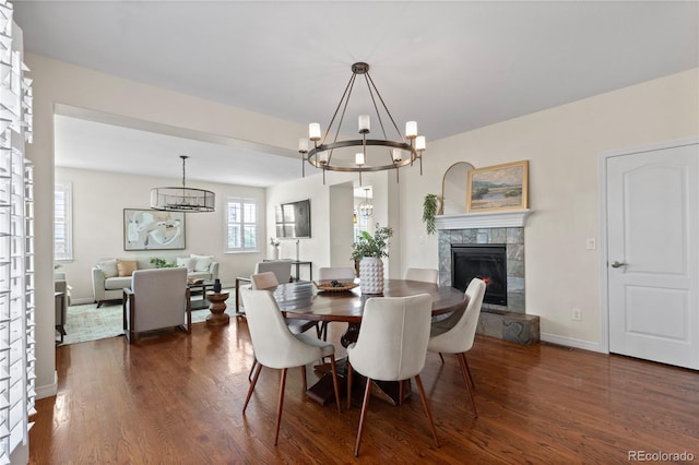 10840 Valleybrook Cir, Highlands Ranch, CO 80130 - dining space featuring a chandelier, dark wood finished floors, and a fireplace