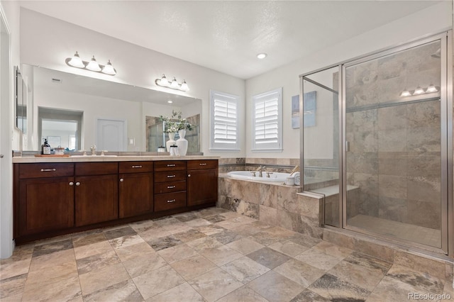 10840 Valleybrook Cir, Highlands Ranch, CO 80130 - bathroom with vanity, a garden tub, a shower stall, stone finish floors, and recessed lighting