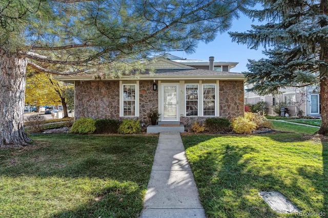 bungalow featuring stone siding and a front lawn