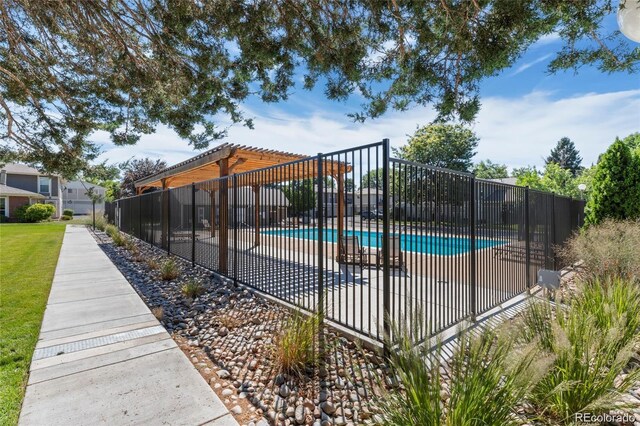 pool with fence and a pergola