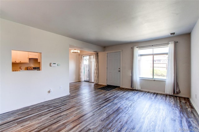 unfurnished living room with dark hardwood / wood-style flooring