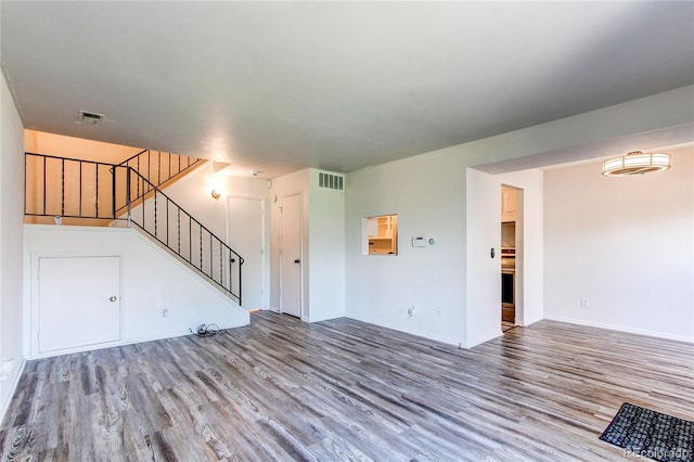 unfurnished living room with wood-type flooring