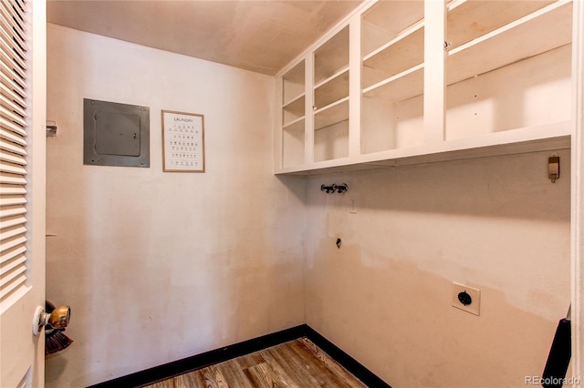 laundry room featuring electric dryer hookup, dark wood-type flooring, and electric panel