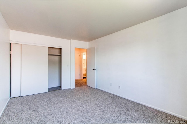 unfurnished bedroom with carpet floors and a closet