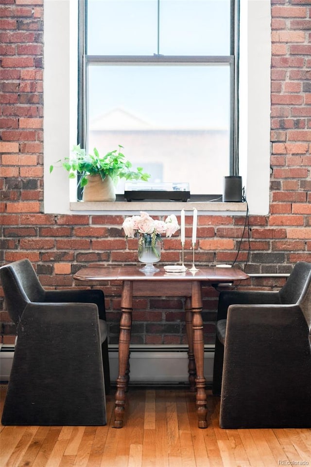 2261 Blake St Unit 2G, Denver, CO 80205 - dining area view of wood finished floors and brick wall