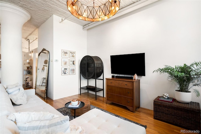 2261 Blake St Unit 2G, Denver, CO 80205 - living area featuring wood finished floors and a chandelier