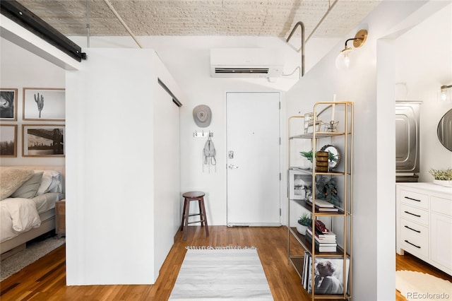 2261 Blake St Unit 2G, Denver, CO 80205 - entryway with a barn door, wood finished floors, and a wall mounted AC