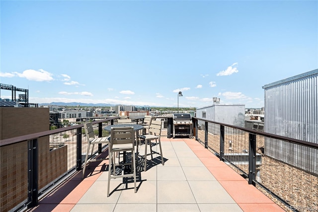 2261 Blake St Unit 2G, Denver, CO 80205 - view of patio with a balcony, a view of city, a mountain view, and area for grilling