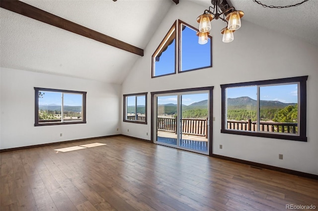 spare room featuring beamed ceiling, high vaulted ceiling, a notable chandelier, and baseboards
