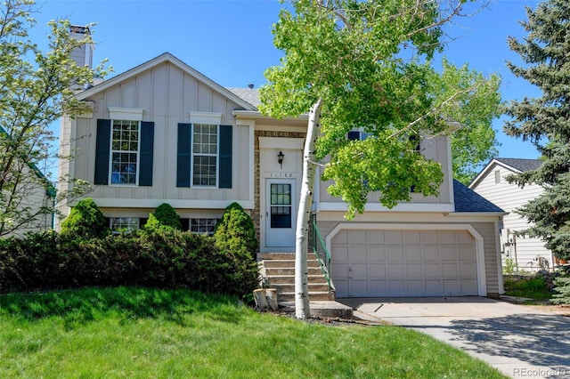 bi-level home with board and batten siding, driveway, a garage, a front lawn, and roof with shingles