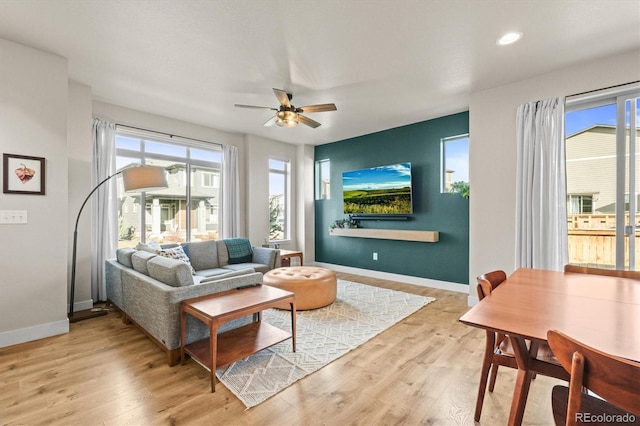 living room featuring recessed lighting, baseboards, a ceiling fan, and wood finished floors