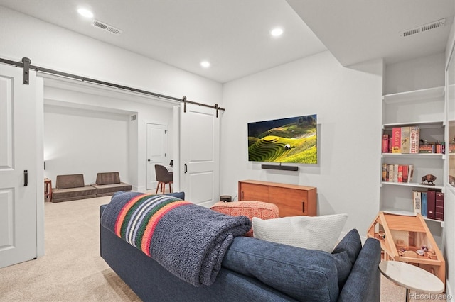 bedroom featuring recessed lighting, a barn door, carpet, and visible vents