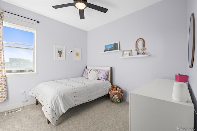 carpeted bedroom featuring visible vents, baseboards, and ceiling fan