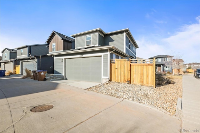 view of front facade with a residential view, a garage, and driveway