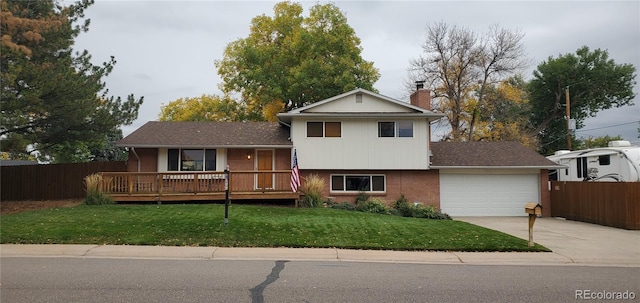 tri-level home with a garage and a front lawn