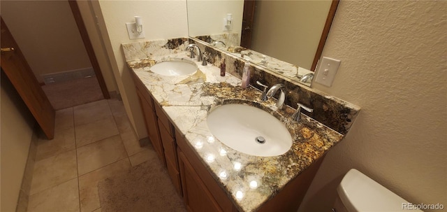 bathroom featuring vanity, toilet, and tile patterned flooring