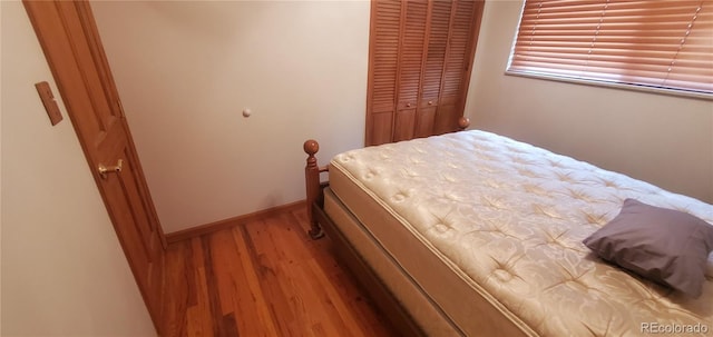 bedroom featuring light hardwood / wood-style floors and a closet