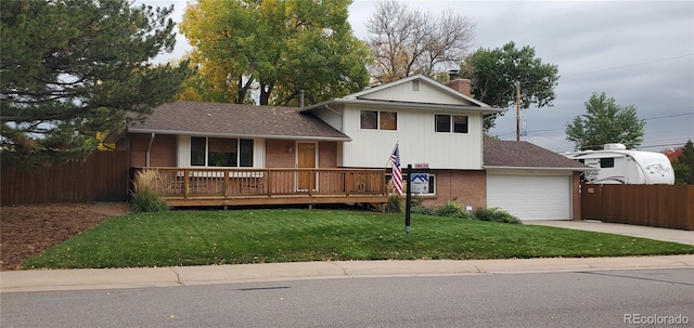 split level home featuring a front yard and a garage