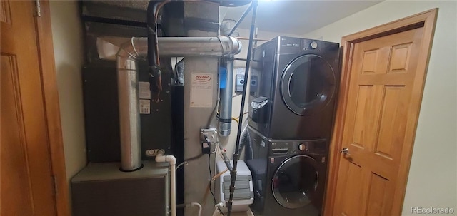 clothes washing area with stacked washer and dryer