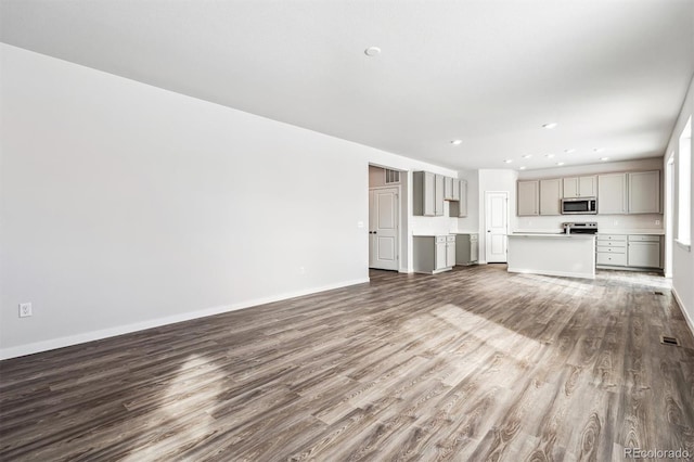 14420 Ranch St, Mead, CO 80504 - unfurnished living room with dark wood-style flooring and recessed lighting