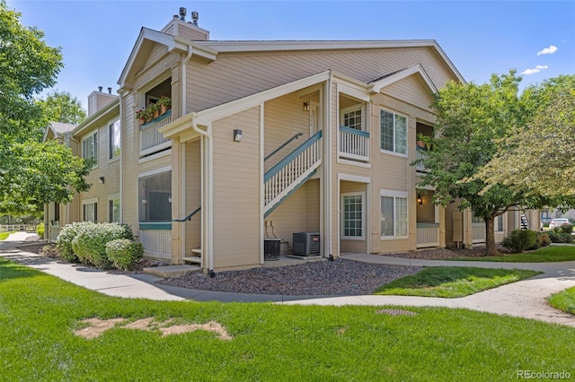 1158 Opal St Unit 203, Broomfield, CO 80020 - view of side of home featuring a chimney, a yard, and a balcony