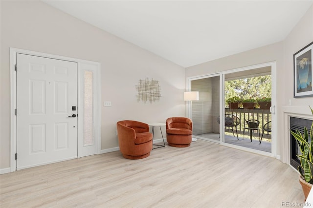 1158 Opal St Unit 203, Broomfield, CO 80020 - living area with wood finished floors, lofted ceiling, and a glass covered fireplace