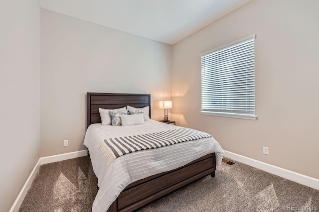 carpeted bedroom featuring visible vents and baseboards