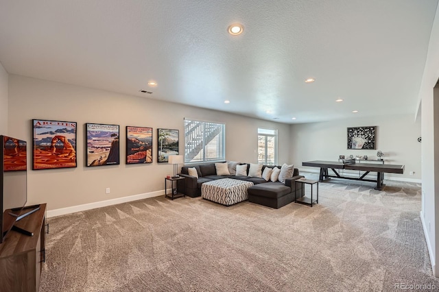 carpeted living room with visible vents, baseboards, a textured ceiling, and recessed lighting