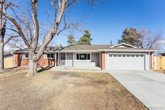 ranch-style house featuring driveway, an attached garage, and brick siding