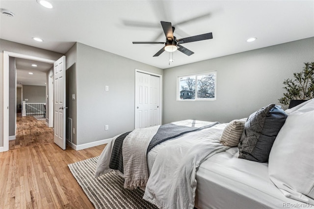 bedroom featuring recessed lighting, a closet, ceiling fan, light wood-type flooring, and baseboards