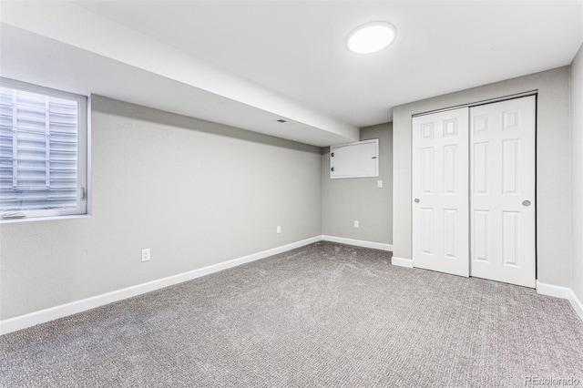 unfurnished bedroom featuring a closet, baseboards, and carpet flooring