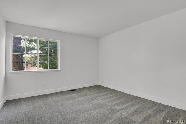 unfurnished room featuring baseboards and carpet flooring