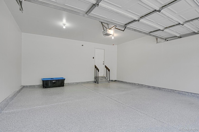 garage with a garage door opener and baseboards