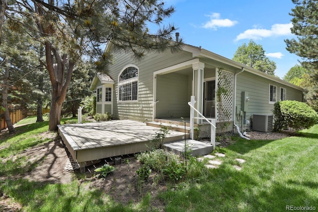 rear view of house featuring central AC and a wooden deck