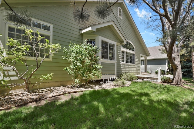 view of home's exterior with a lawn