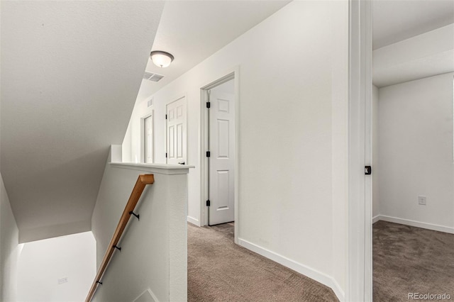 hallway with light colored carpet