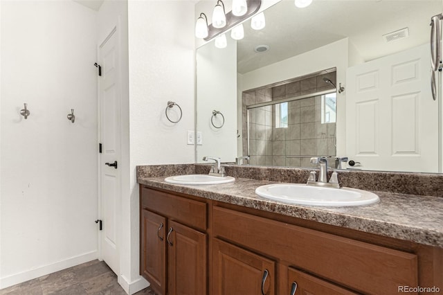 bathroom with vanity, a shower with shower door, and tile patterned floors